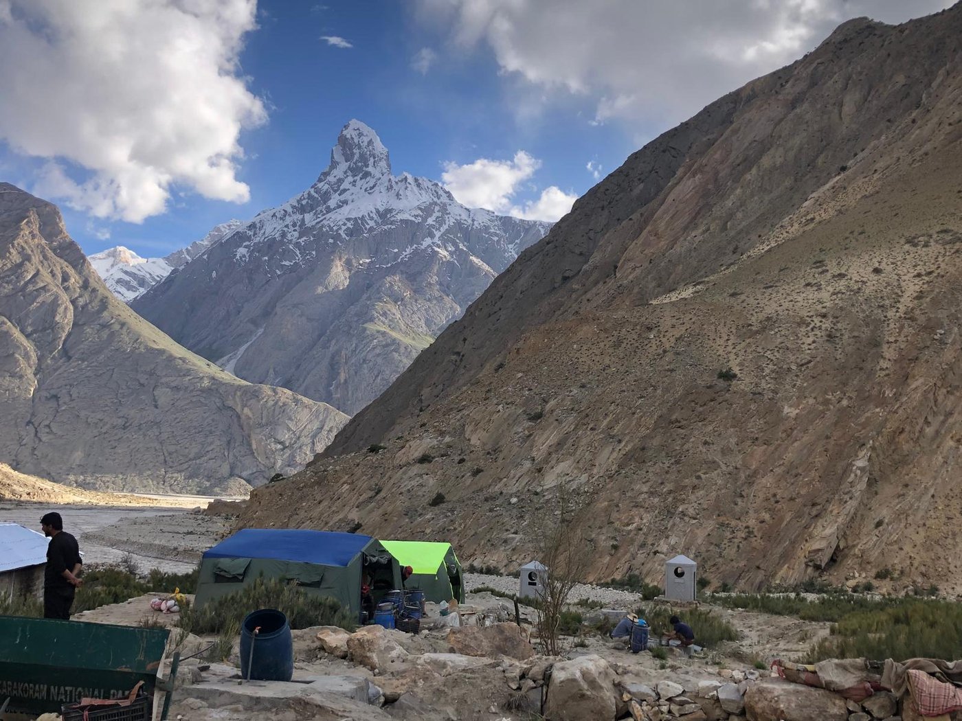 Tents pitched in a valley below the mountains at Askole